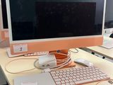 a desk with two computers and a keyboard on it