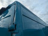 a blue van that is parked on the side of the road