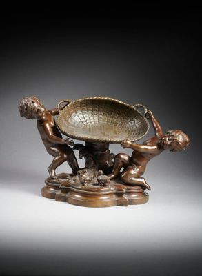 an image of a bronze sculpture of a boy and a boy playing with a bowl