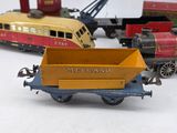 several toy trains are lined up in a row on a white surface