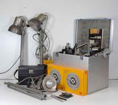 a silver box with a yellow box on top of it next to a pair of lamps and a pair of scissors
