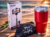a red cup and a black bag sitting on top of a wooden table
