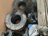 a cardboard box filled with assorted items like tires, wheels, and other items