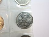 six different types of coins in a display case