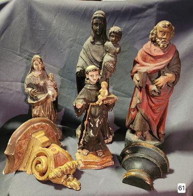 five figurines that are sitting on a blue cloth