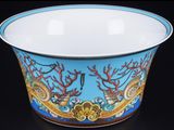a bowl with a design on it on a black surface