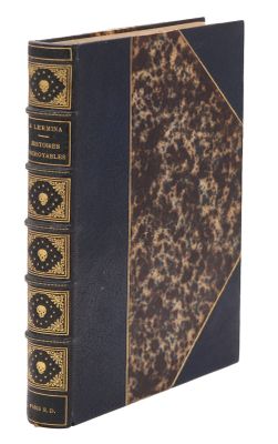 an old book with a black cover and gold trim
