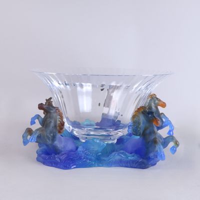 a glass bowl with a horse and a boat inside of it