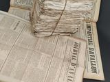 several old newspapers stacked on top of each other on a table