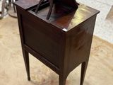 a small wooden table with a laptop on top of it
