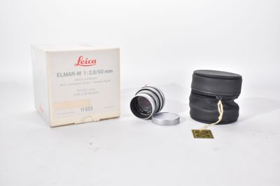 a close up of a camera lens and a box of lenses