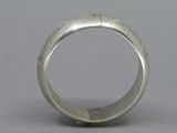 an image of a silver ring on a gray surface