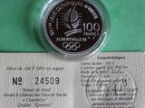 a picture of a silver coin on a green surface