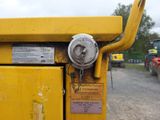 a close up of a yellow dump truck with a sign on it