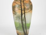 a vase with a painting on it sitting on a table