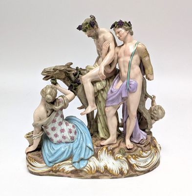 a figurine of a group of people sitting on a rock