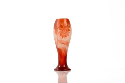 a glass vase with a red and white design on it