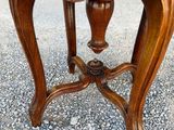 an image of a wooden table with a glass top on a gravel ground