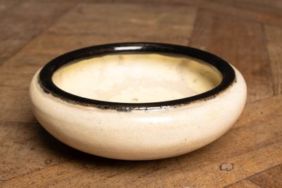 a bowl of soup sitting on a wooden table
