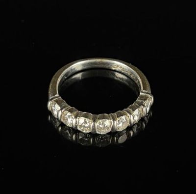 une image d'une bague en diamant sur une surface noire