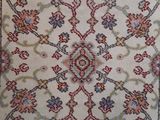 an antique persian rug with a floral design on a white ground