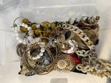 a box full of assorted jewelry on a table