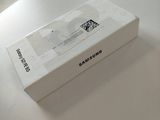 a white box sitting on top of a table next to a cell phone