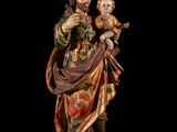 an image of a statue of a man holding a child