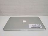 a silver apple laptop sitting on a white table