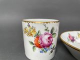 a cup and a bowl that are sitting next to each other