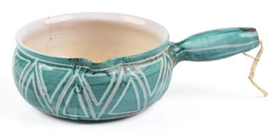 a green cup with a spoon sticking out of it