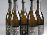 six bottles of champagne are lined up in a row