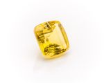 a yellow sapphire stone on a white background