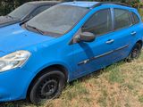 two small cars parked in the grass next to each other