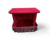 a small red box that is on a white surface