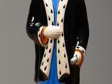 a figurine of a man wearing a robe and a hat