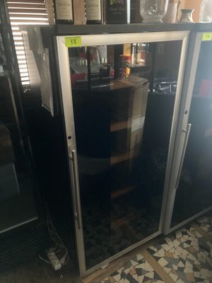 une photo d'un réfrigérateur dans une cuisine, avec une porte vitrée