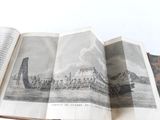 an open book with a picture of a boat in the water