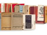 several books are stacked on top of each other on a white surface