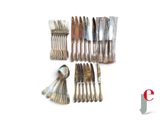 a lot of forks and spoons that are on the table