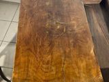 a wooden table with a drawer on top of it