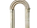 a stone arch that has a clock on top of it