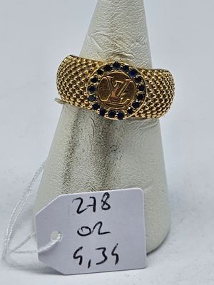 a close up of a gold ring with blue stones on it
