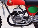 a red and green motorcycle parked on the side of the road