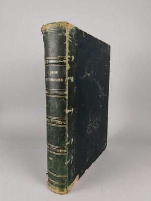 an old book sitting on top of a white table