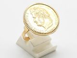 an image of a ring with a gold coin on top of it