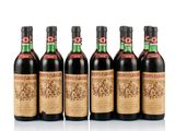 four bottles of wine are lined up in a row