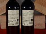two bottles of wine sitting next to each other on a table