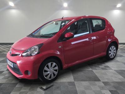 a picture of a red car parked in a garage