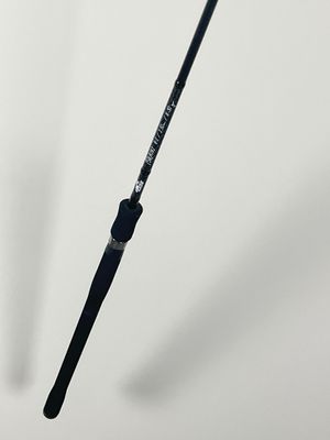 a close up of a fishing rod on a white surface